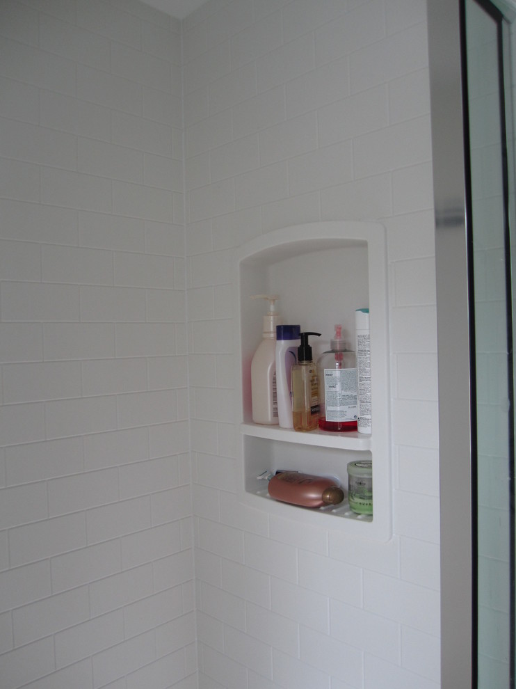 Example of a small transitional white tile alcove shower design in Boston with an undermount sink, recessed-panel cabinets, dark wood cabinets, granite countertops, a two-piece toilet, green walls and a hinged shower door