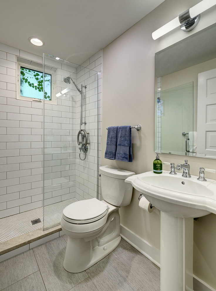 Пример оригинального дизайна: маленькая главная ванная комната в стиле неоклассика (современная классика) с плоскими фасадами, открытым душем, раздельным унитазом, белой плиткой, керамической плиткой, белыми стенами, полом из керамогранита, раковиной с пьедесталом, столешницей из искусственного кварца, серым полом, душем с распашными дверями, разноцветной столешницей и коричневыми фасадами для на участке и в саду