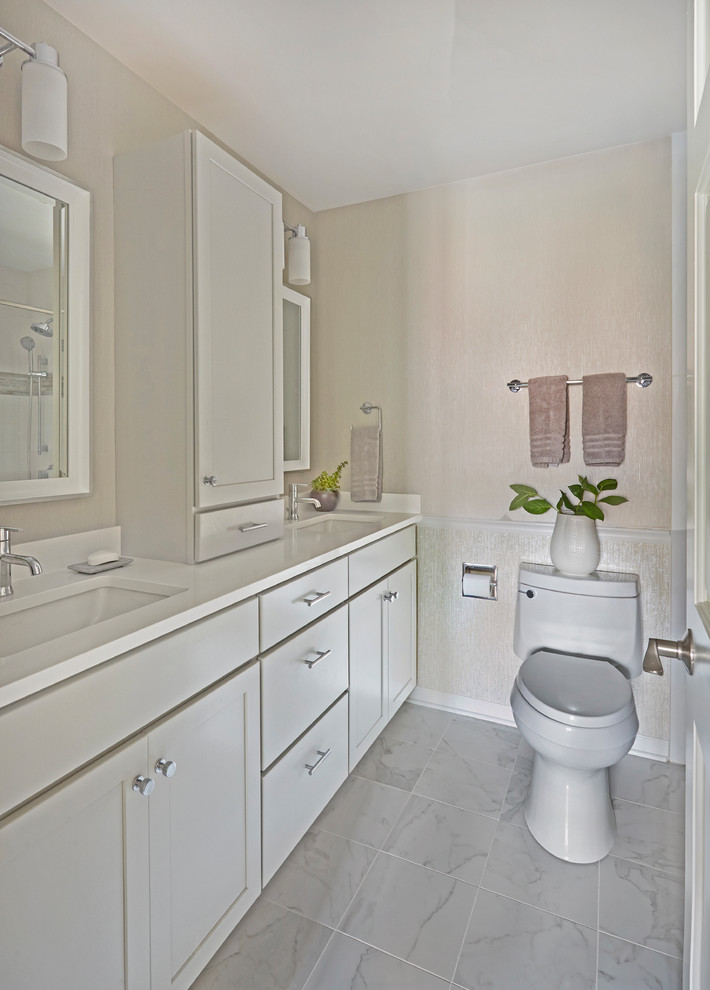 Photo of a medium sized traditional family bathroom in Chicago with shaker cabinets, white cabinets, beige tiles, beige walls, porcelain flooring, a submerged sink, engineered stone worktops, white floors, white worktops, an alcove bath, a one-piece toilet, an alcove shower, ceramic tiles and a shower curtain.