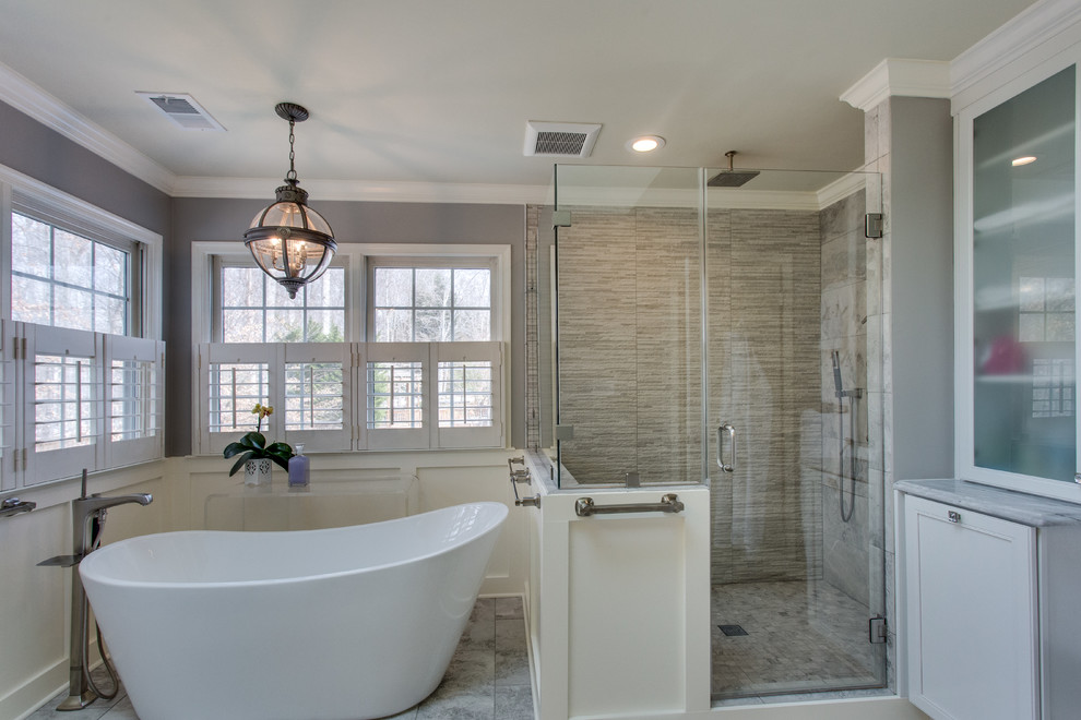 This is an example of a large traditional ensuite bathroom in DC Metro with recessed-panel cabinets, white cabinets, a freestanding bath, a corner shower, a submerged sink and granite worktops.