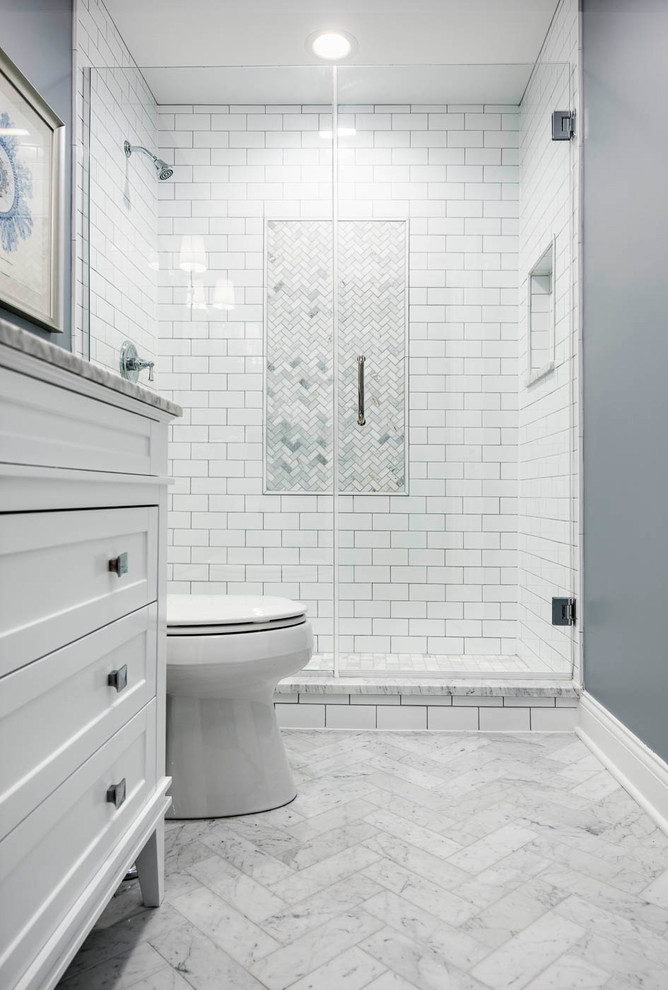 Mid-sized transitional 3/4 white tile and subway tile marble floor and white floor alcove shower photo in Chicago with recessed-panel cabinets, white cabinets, a two-piece toilet, gray walls and a hinged shower door