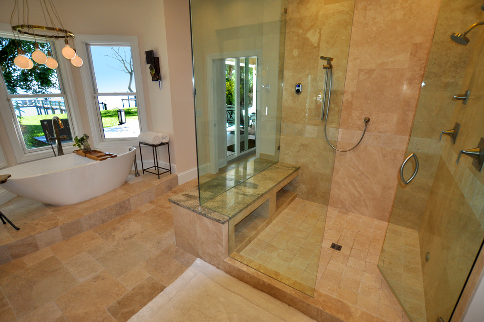This is an example of a large traditional ensuite bathroom in Tampa with shaker cabinets, dark wood cabinets, a freestanding bath, a corner shower, beige tiles, ceramic tiles, beige walls, ceramic flooring, a submerged sink, glass worktops, beige floors, a hinged door and green worktops.