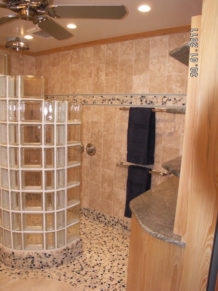 Example of a large island style master beige tile and stone tile porcelain tile walk-in shower design in Miami with flat-panel cabinets, light wood cabinets, a one-piece toilet, beige walls, an undermount sink and granite countertops