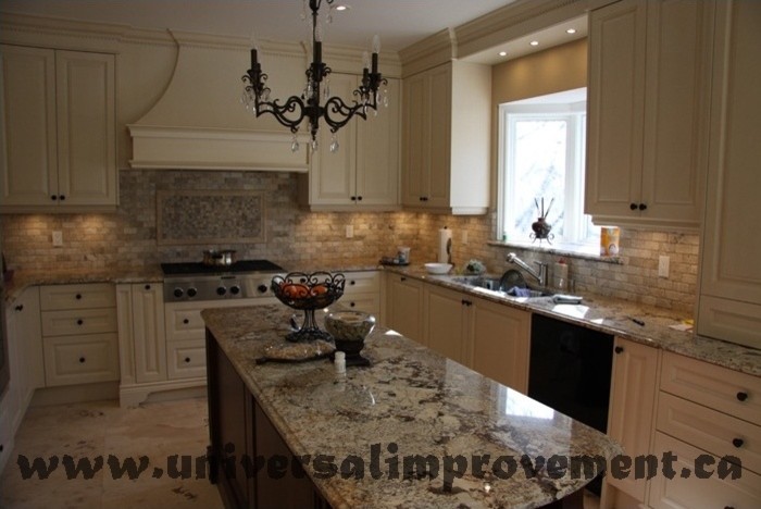 This is an example of a large victorian kitchen in Toronto with beige cabinets, travertine flooring and beige floors.