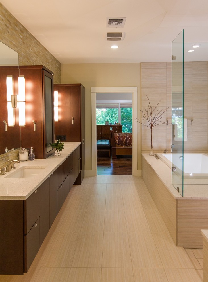 Example of a large trendy master beige tile and porcelain tile travertine floor and beige floor bathroom design in Austin with flat-panel cabinets, dark wood cabinets, beige walls, an undermount sink and limestone countertops
