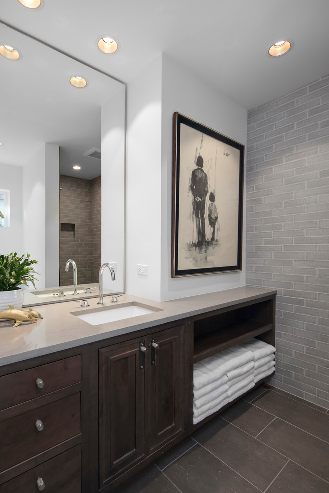 This is an example of a medium sized contemporary bathroom in Seattle with recessed-panel cabinets, brown cabinets, a one-piece toilet, grey tiles, ceramic tiles, white walls, porcelain flooring, a submerged sink, engineered stone worktops, grey floors and an open shower.