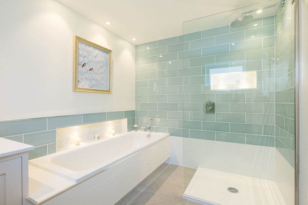 Design ideas for a medium sized contemporary ensuite bathroom in Cornwall with recessed-panel cabinets, white cabinets, a built-in bath, a walk-in shower, green tiles, ceramic tiles, white walls, limestone flooring, an open shower and a built in vanity unit.