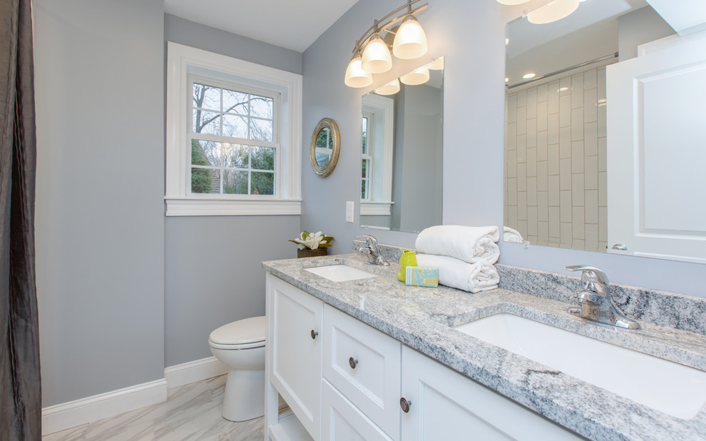 Bathroom - mid-sized transitional 3/4 white tile and ceramic tile ceramic tile and white floor bathroom idea in Boston with furniture-like cabinets, white cabinets, a two-piece toilet, gray walls, an undermount sink and granite countertops