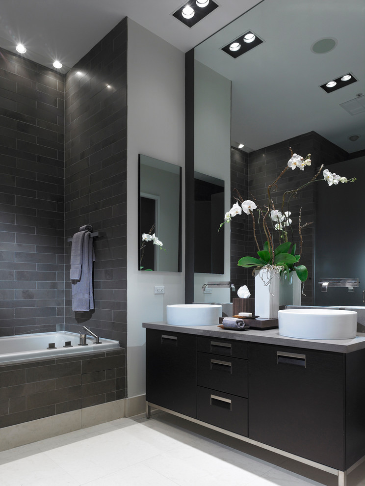 Contemporary bathroom in New York with flat-panel cabinets, black cabinets and a vessel sink.