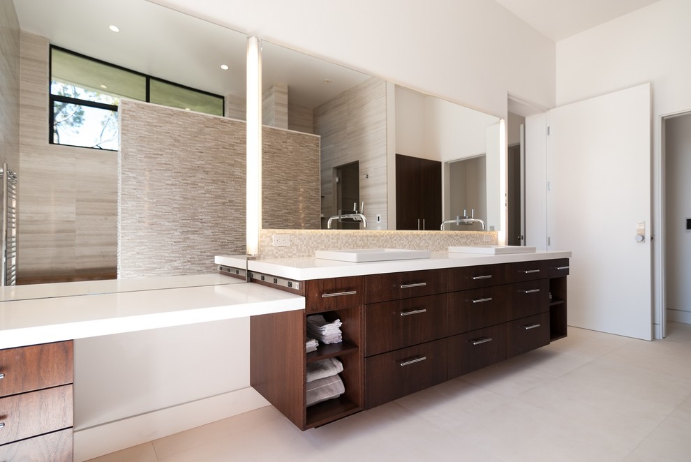 Large modern ensuite bathroom in San Diego with flat-panel cabinets, dark wood cabinets, beige tiles, stone tiles, a walk-in shower, white walls, ceramic flooring, a built-in sink and quartz worktops.