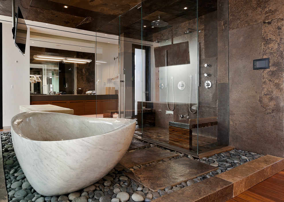 Inspiration for a contemporary bathroom in Las Vegas with flat-panel cabinets, dark wood cabinets, a freestanding bath, a double shower, brown tiles and beige walls.