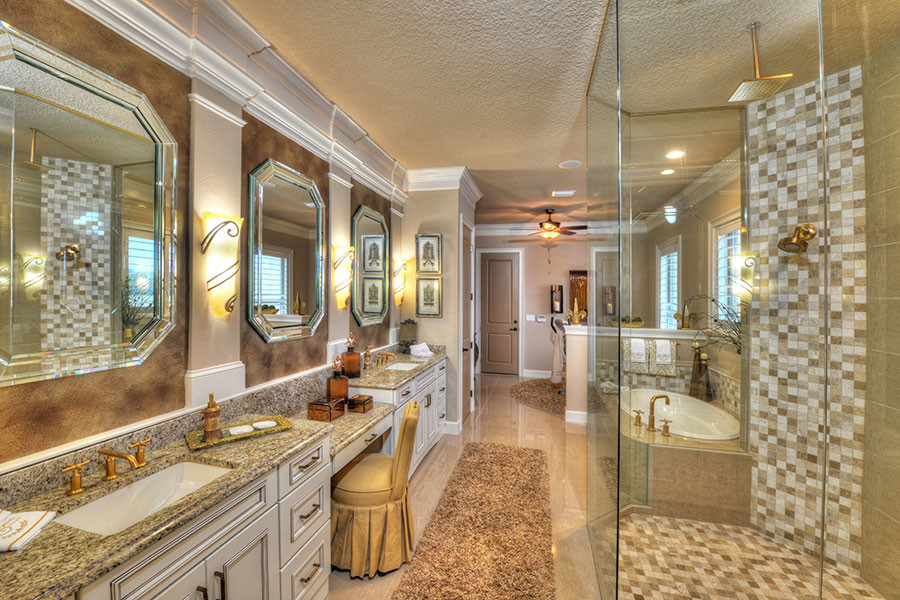 Large traditional ensuite bathroom in Orlando with a submerged sink, recessed-panel cabinets, white cabinets, granite worktops, a built-in bath, a built-in shower, brown tiles, glass tiles, beige walls and marble flooring.