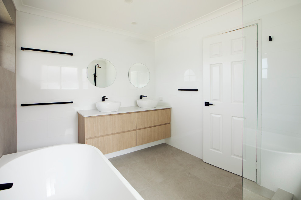 Large contemporary ensuite bathroom in Perth with shaker cabinets, medium wood cabinets, a freestanding bath, a corner shower, a one-piece toilet, white walls, a vessel sink, grey floors, an open shower and white worktops.