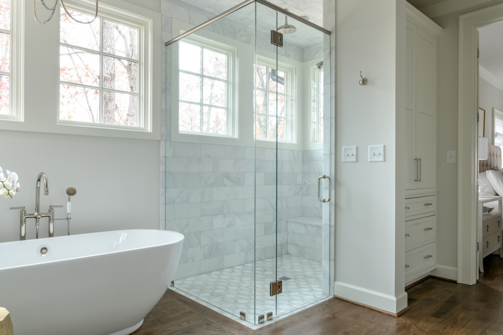 Large transitional master gray tile medium tone wood floor and brown floor bathroom photo in Birmingham with shaker cabinets, white cabinets, gray walls and a hinged shower door
