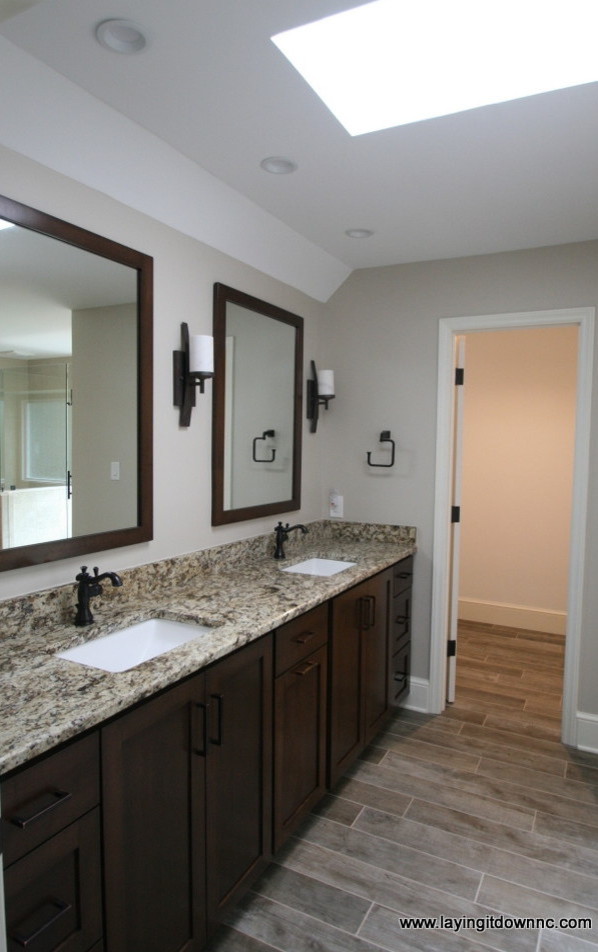 Classic ensuite bathroom in Charlotte with beige walls, ceramic flooring and a submerged sink.