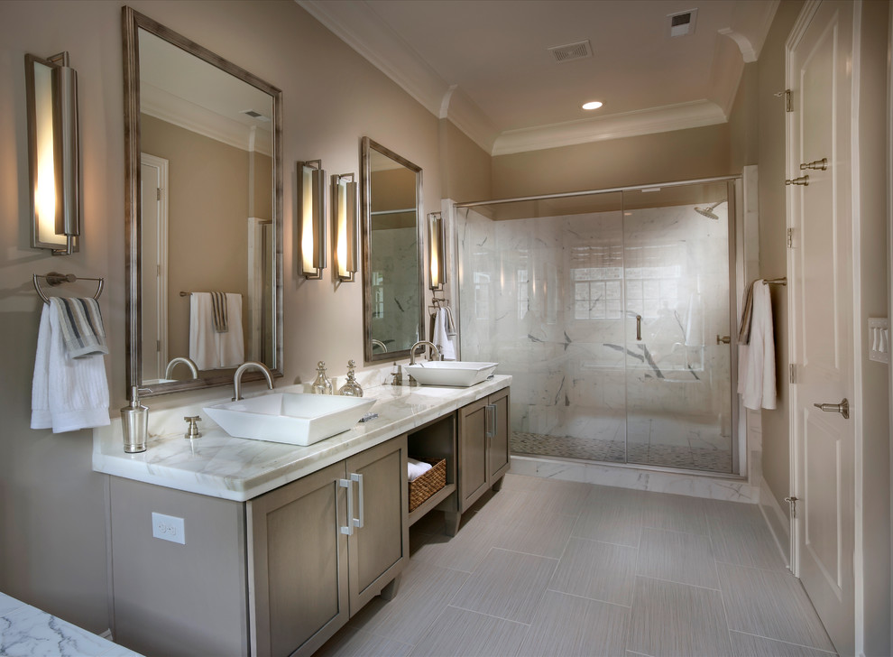 Inspiration for a large classic ensuite bathroom in Charlotte with a vessel sink, grey cabinets, granite worktops, an alcove shower, a two-piece toilet, grey tiles, ceramic tiles, beige walls, ceramic flooring and shaker cabinets.