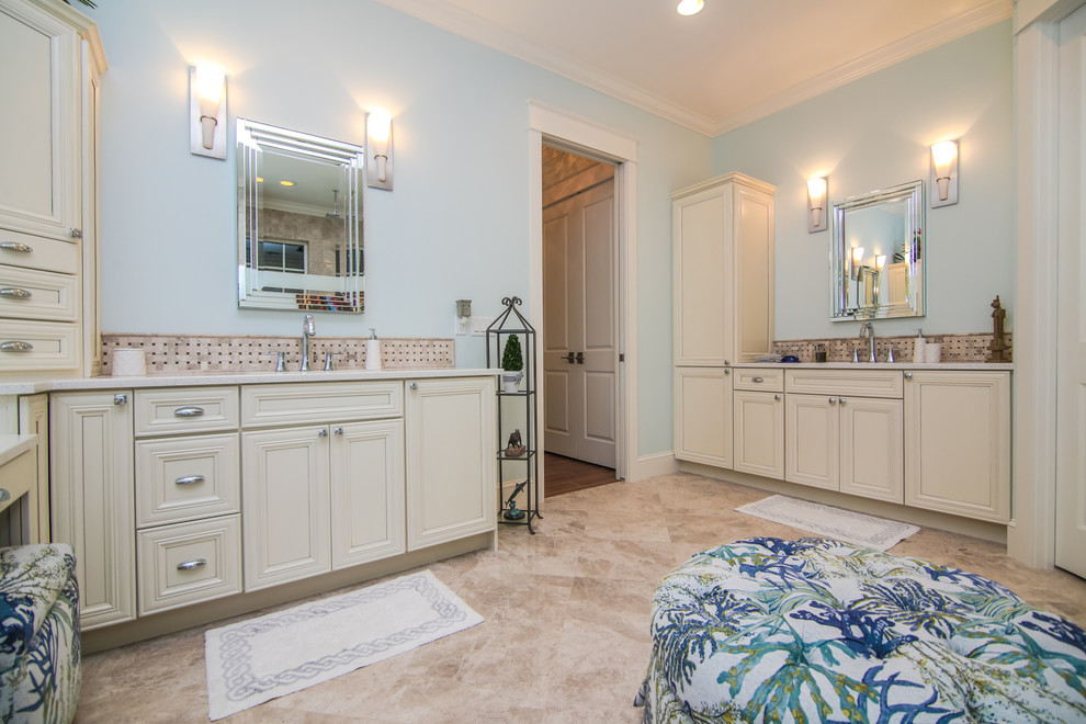 Example of a mid-sized beach style master linoleum floor bathroom design in Miami with recessed-panel cabinets, white cabinets, a one-piece toilet, blue walls, an undermount sink and quartz countertops