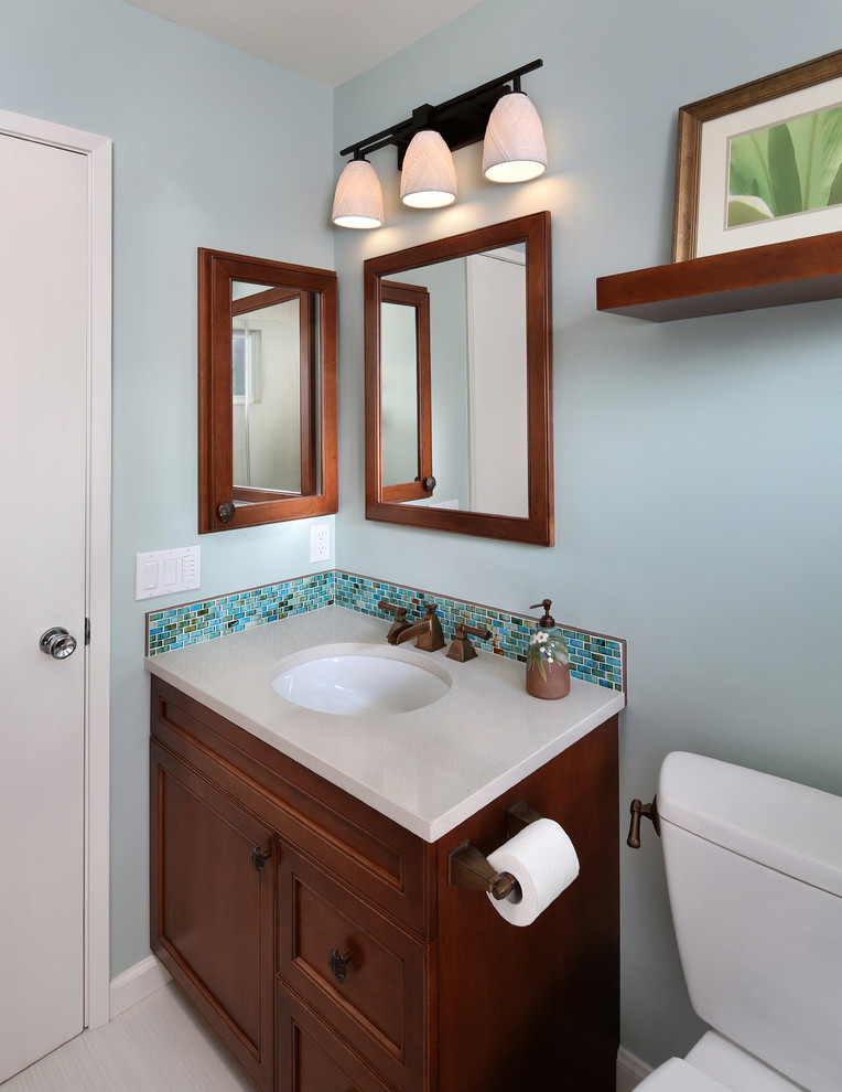 Idées déco pour une petite douche en alcôve exotique en bois brun avec un lavabo encastré, un placard avec porte à panneau encastré, un plan de toilette en quartz modifié, un mur bleu et un sol en carrelage de porcelaine.