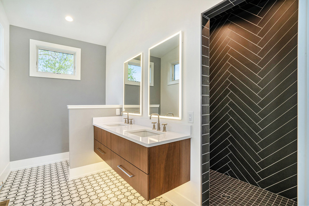 Large transitional master ceramic tile and multicolored floor bathroom photo in Grand Rapids with flat-panel cabinets, medium tone wood cabinets, gray walls, solid surface countertops, white countertops and an undermount sink