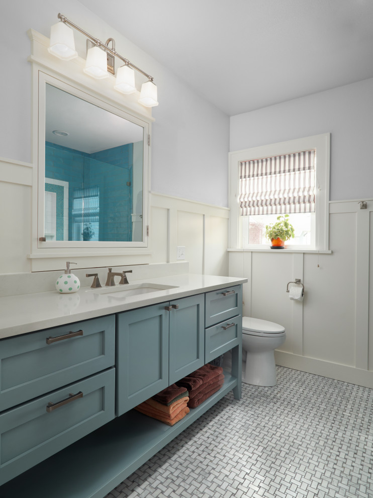Inspiration for a medium sized traditional bathroom in Portland with recessed-panel cabinets, blue cabinets, an alcove shower, a two-piece toilet, blue tiles, metro tiles, grey walls, marble flooring, a submerged sink, quartz worktops, white floors, a hinged door and white worktops.