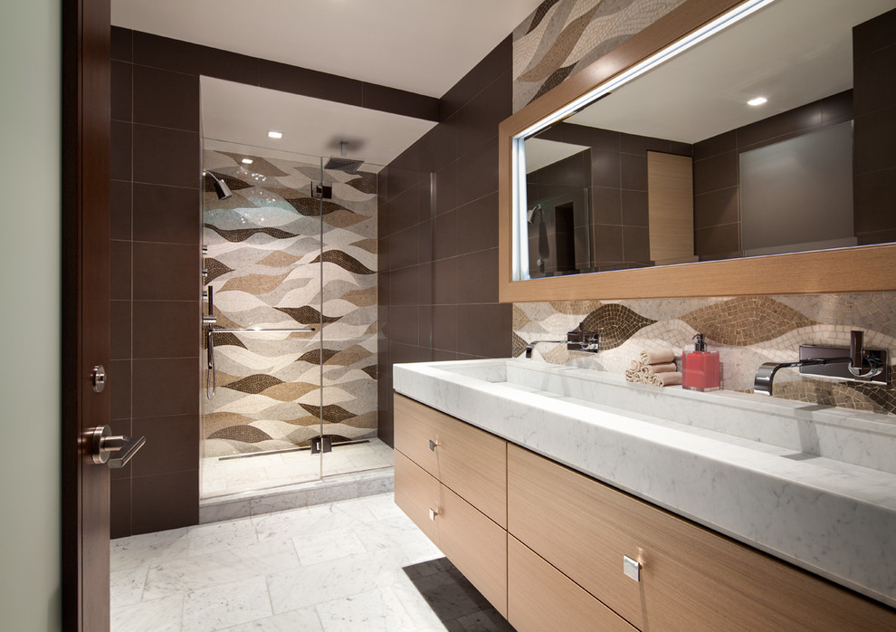 Design ideas for a medium sized contemporary shower room bathroom in New York with flat-panel cabinets, light wood cabinets, a corner shower, white tiles, multi-coloured walls, marble flooring, a trough sink and marble worktops.