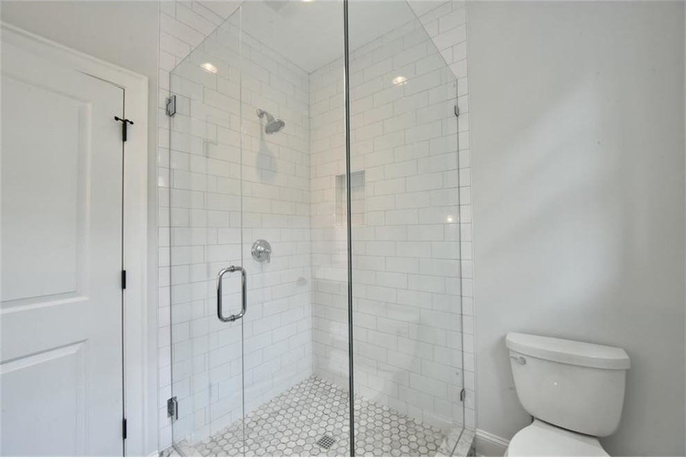Aménagement d'une salle de bain classique de taille moyenne avec un placard à porte shaker, une douche d'angle, un carrelage blanc, un carrelage métro, un mur gris, un lavabo encastré, des portes de placard grises et un sol en carrelage de terre cuite.