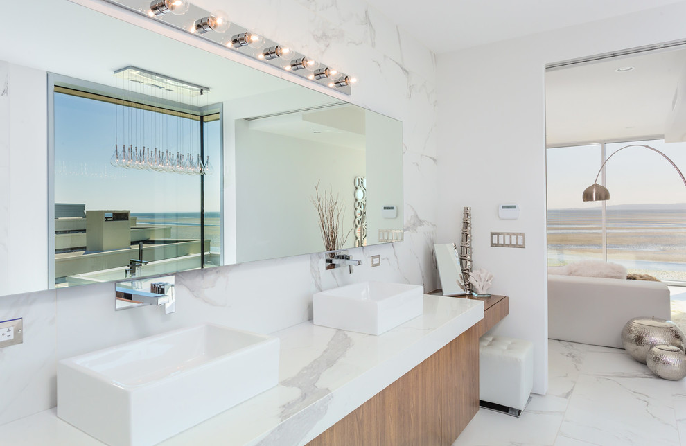 Bathroom - mid-sized modern master white tile and porcelain tile ceramic tile and white floor bathroom idea in Vancouver with flat-panel cabinets, light wood cabinets, white walls, a vessel sink, marble countertops, white countertops and a wall-mount toilet