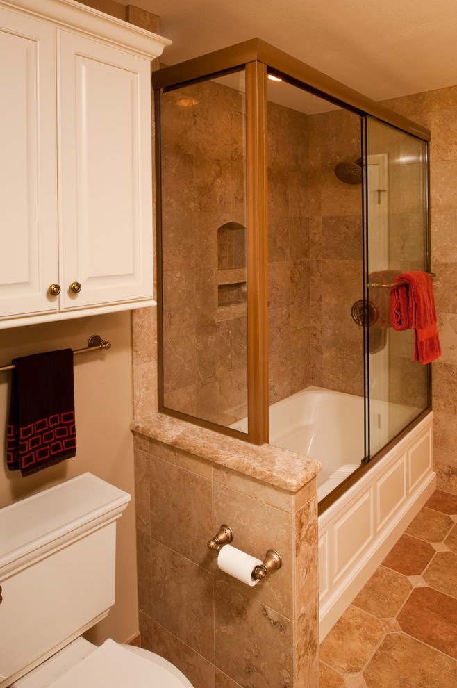 Bathroom - mid-sized traditional brown tile and stone tile porcelain tile bathroom idea in Other with a drop-in sink, raised-panel cabinets, beige cabinets, marble countertops and brown walls
