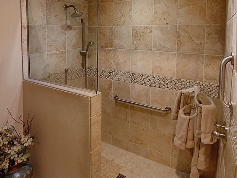 Example of an arts and crafts brown tile doorless shower design in Phoenix