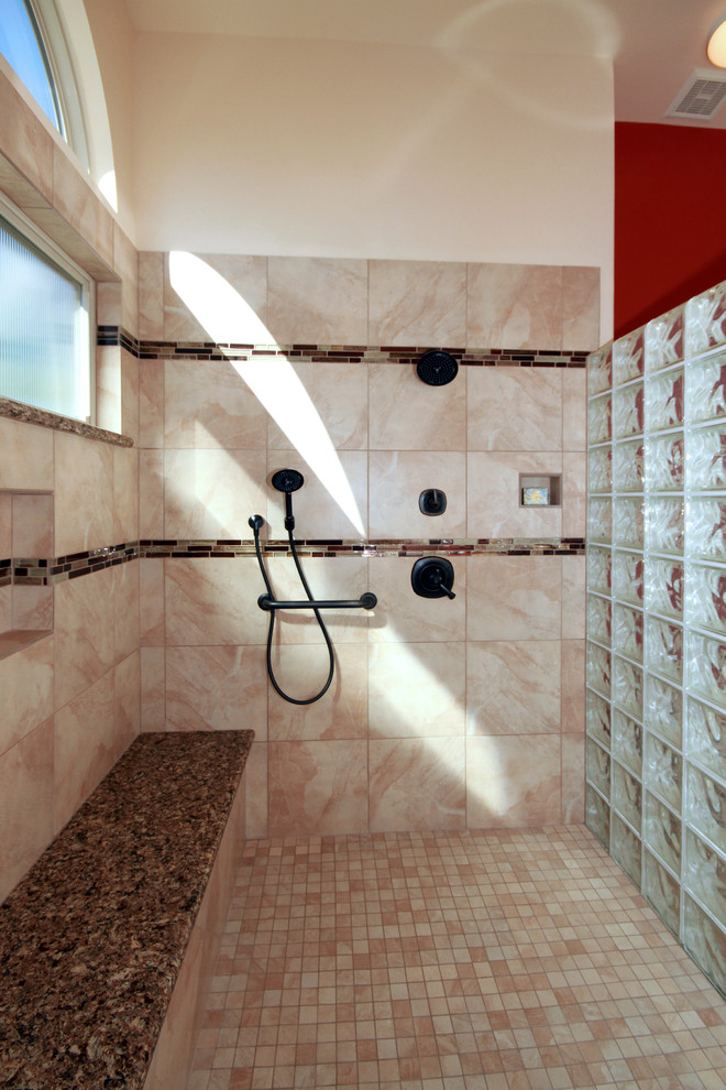 Inspiration for a southwestern master beige tile and ceramic tile ceramic tile doorless shower remodel in Phoenix with shaker cabinets, medium tone wood cabinets, a two-piece toilet, an undermount sink and quartzite countertops