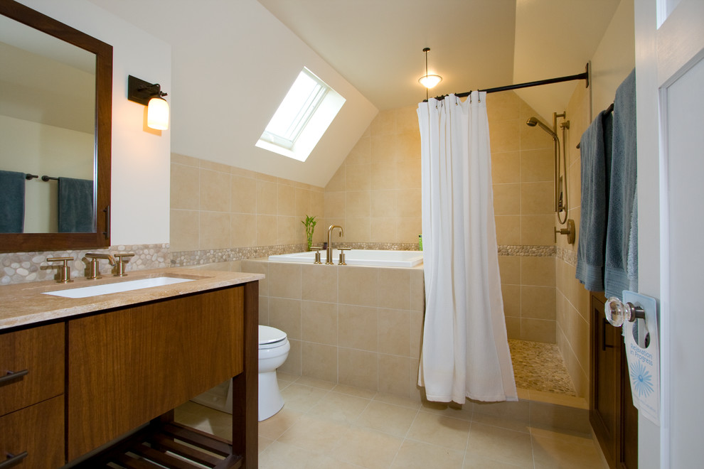 Example of a mid-sized transitional master beige tile and ceramic tile ceramic tile and beige floor bathroom design in Milwaukee with flat-panel cabinets, medium tone wood cabinets, a two-piece toilet, beige walls, an undermount sink and soapstone countertops