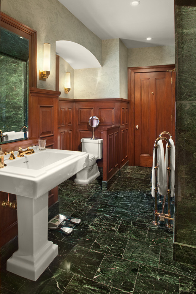 Inspiration for a large traditional ensuite bathroom in Cleveland with raised-panel cabinets, medium wood cabinets, a two-piece toilet, green tiles, stone slabs, green walls, marble flooring and a pedestal sink.