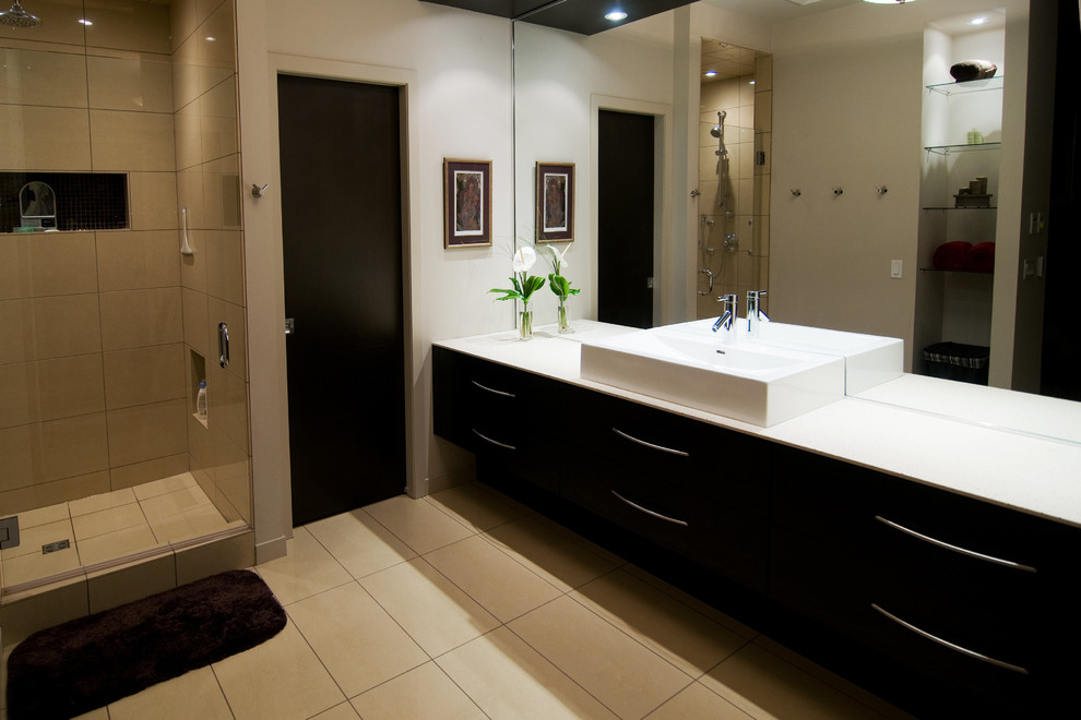 Design ideas for a large modern ensuite bathroom in Toronto with freestanding cabinets, dark wood cabinets, a corner shower, a one-piece toilet, beige tiles, ceramic tiles, white walls, ceramic flooring, a vessel sink and engineered stone worktops.