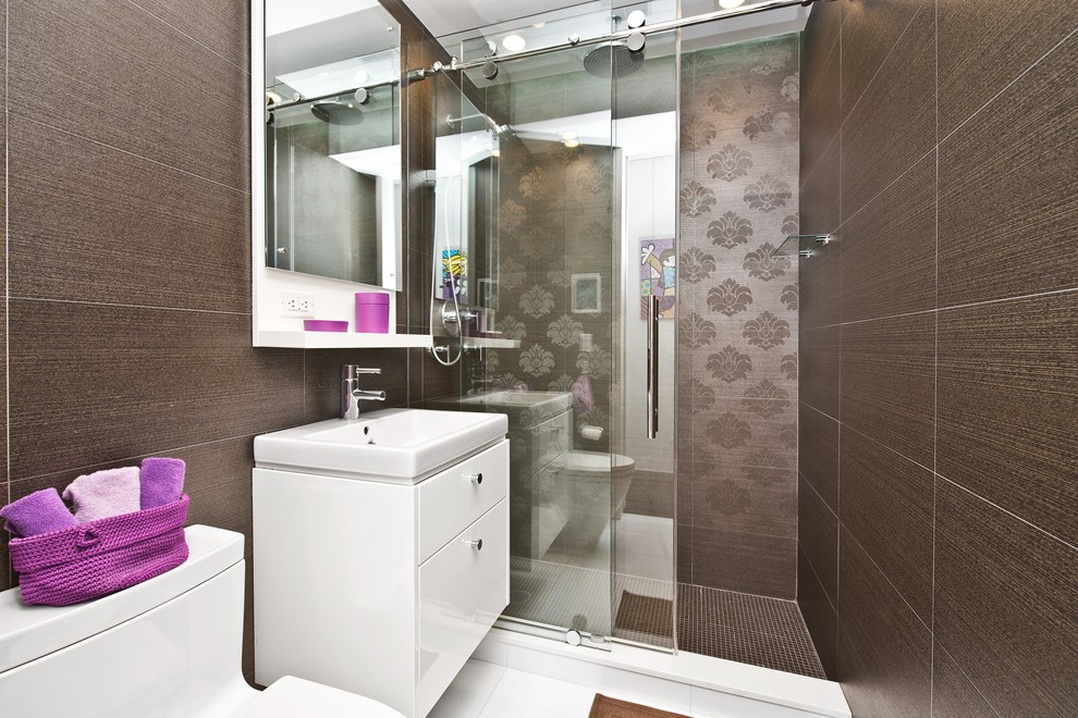 Inspiration for a small contemporary shower room bathroom in New York with flat-panel cabinets, white cabinets, an alcove shower, a one-piece toilet, brown walls, porcelain flooring, a built-in sink, white floors and a sliding door.