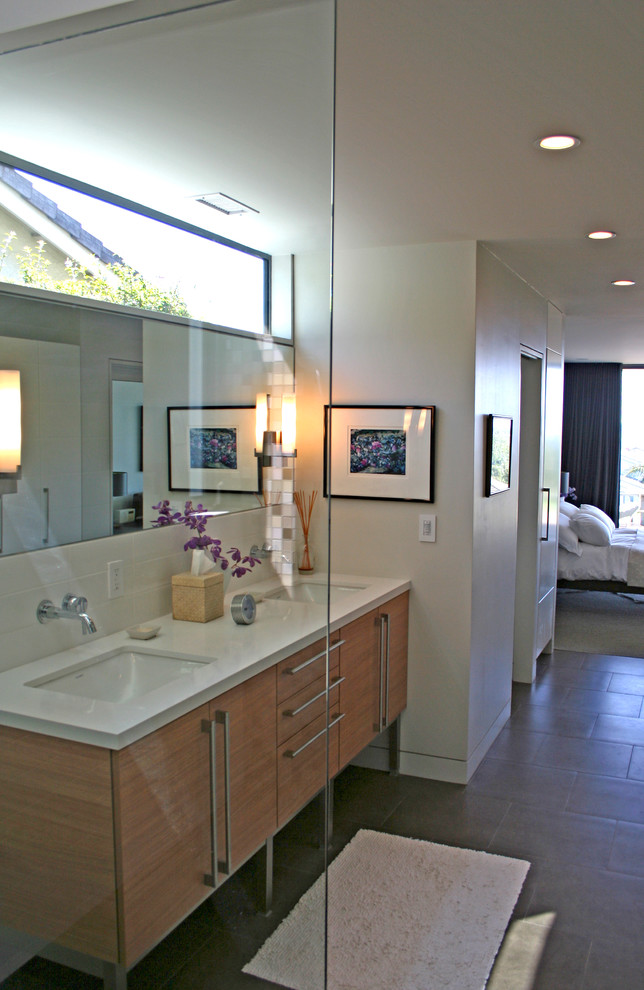 Design ideas for a medium sized modern ensuite bathroom in Orange County with a vessel sink, freestanding cabinets, medium wood cabinets, glass worktops, a walk-in shower, grey tiles, white walls and porcelain flooring.