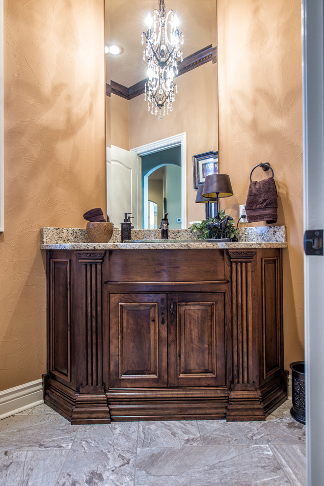 Example of a large tuscan 3/4 porcelain tile bathroom design in Other with furniture-like cabinets, medium tone wood cabinets, granite countertops, beige walls and a drop-in sink