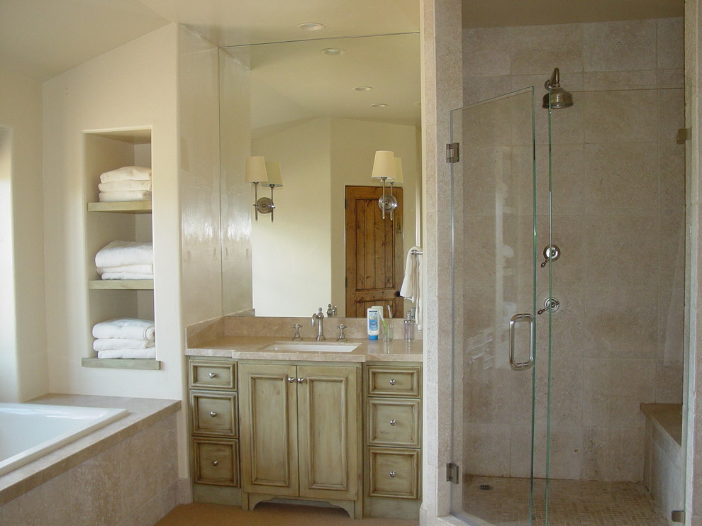 This is an example of a mediterranean ensuite bathroom in San Francisco with a submerged sink, beaded cabinets, light wood cabinets and an alcove shower.