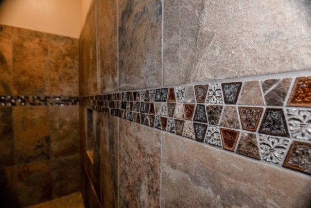 Example of a mid-sized tuscan master beige tile and mosaic tile pebble tile floor freestanding bathtub design in Other with beige walls and an undermount sink