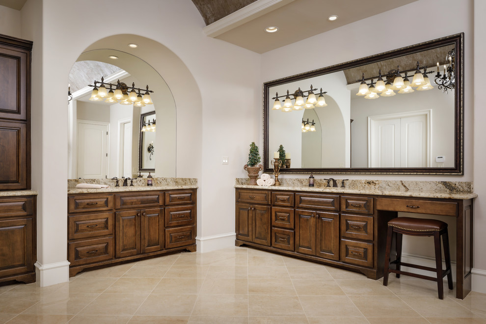 Design ideas for a large mediterranean ensuite bathroom in Houston with raised-panel cabinets, dark wood cabinets, a freestanding bath, a walk-in shower, a one-piece toilet, beige tiles, mosaic tiles, beige walls, porcelain flooring, a built-in sink, granite worktops, beige floors, an open shower and brown worktops.