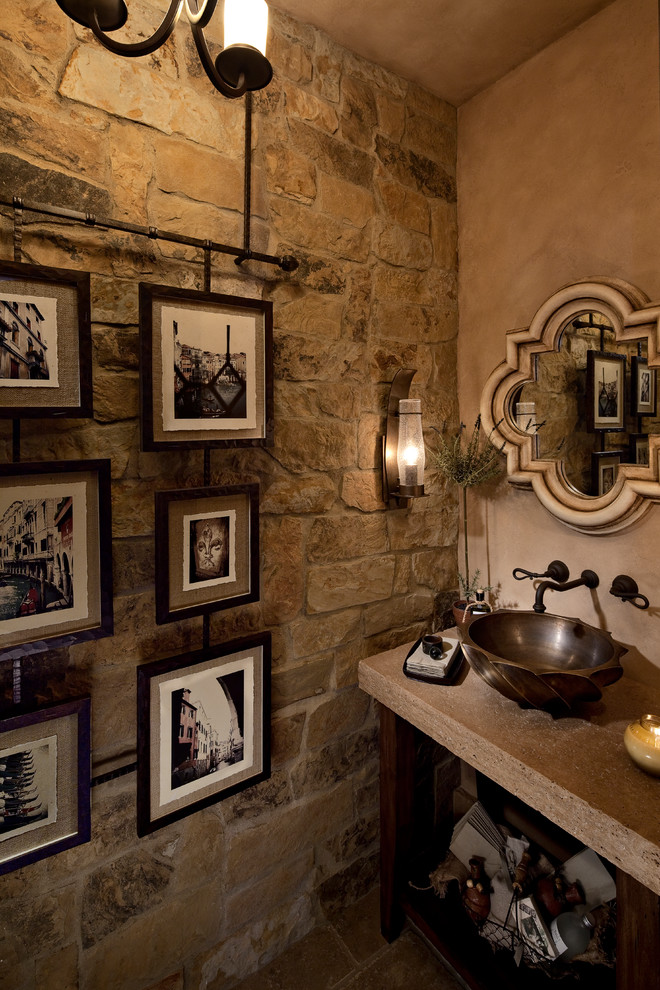 Example of a mid-sized tuscan 3/4 brown tile and stone tile travertine floor bathroom design in Orange County with furniture-like cabinets, distressed cabinets, a two-piece toilet, beige walls, a vessel sink and solid surface countertops