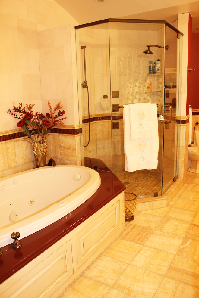 Example of a large tuscan master stone tile and beige tile porcelain tile bathroom design in New York with shaker cabinets, a two-piece toilet, beige walls, medium tone wood cabinets, a vessel sink and granite countertops