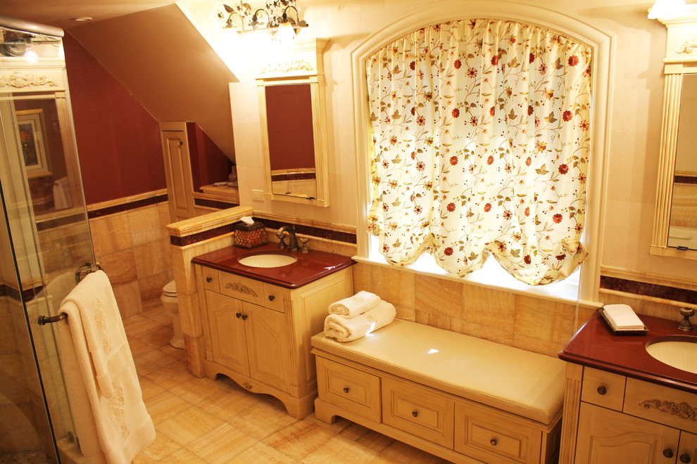 Photo of a large mediterranean ensuite bathroom in New York with shaker cabinets, an alcove bath, a two-piece toilet, stone tiles, beige walls and porcelain flooring.