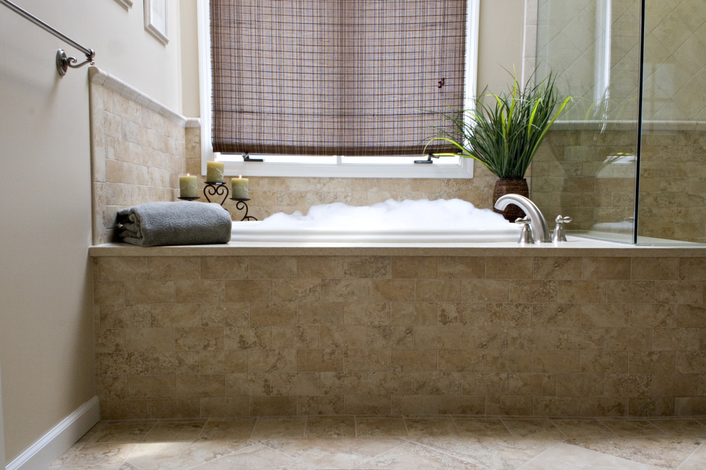 Cette image montre une salle de bain principale méditerranéenne en bois brun de taille moyenne avec un lavabo encastré, un placard avec porte à panneau surélevé, un plan de toilette en quartz modifié, une baignoire posée, un combiné douche/baignoire, WC séparés, un carrelage beige, des carreaux de porcelaine, un mur beige et un sol en carrelage de porcelaine.