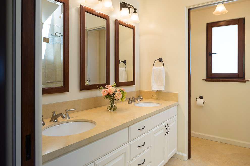 Example of a mid-sized tuscan master limestone floor double shower design in San Francisco with an undermount sink, raised-panel cabinets, white cabinets, limestone countertops, a bidet and white walls