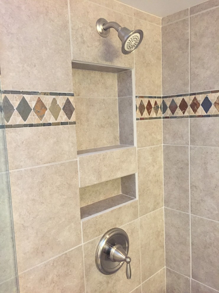 Example of a mid-sized trendy master multicolored tile and ceramic tile ceramic tile doorless shower design in Cleveland with furniture-like cabinets, medium tone wood cabinets, beige walls, an undermount sink and granite countertops