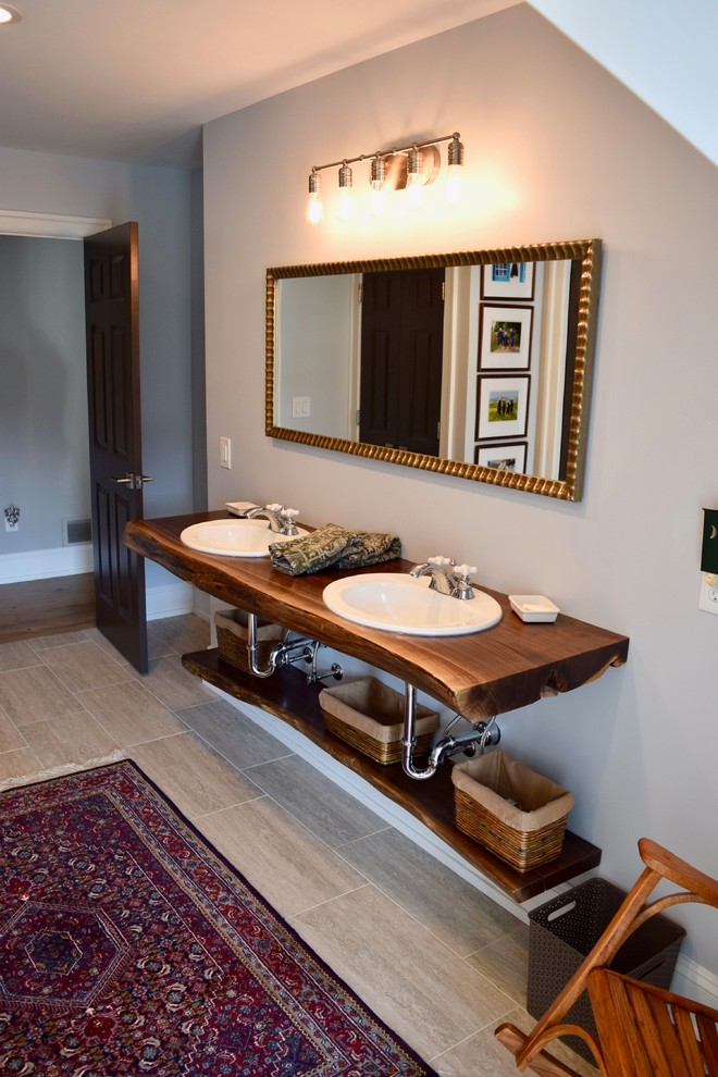На фото: главная ванная комната среднего размера в стиле неоклассика (современная классика) с серыми стенами, полом из керамогранита, накладной раковиной, столешницей из дерева, бежевым полом, душем с распашными дверями и коричневой столешницей