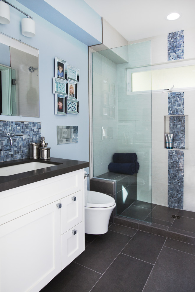 Inspiration for a small contemporary shower room bathroom in Orange County with a submerged sink, shaker cabinets, white cabinets, engineered stone worktops, an alcove shower, a wall mounted toilet, grey tiles, porcelain tiles, blue walls and porcelain flooring.