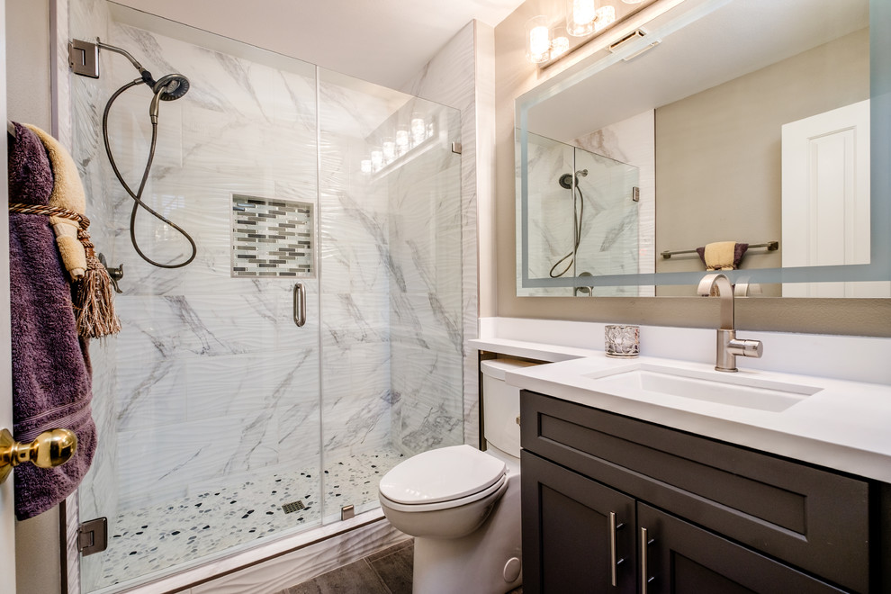 Inspiration for a mid-sized transitional 3/4 gray tile, white tile and stone tile brown floor alcove shower remodel in Orange County with shaker cabinets, brown cabinets, a two-piece toilet, brown walls, an undermount sink and a hinged shower door