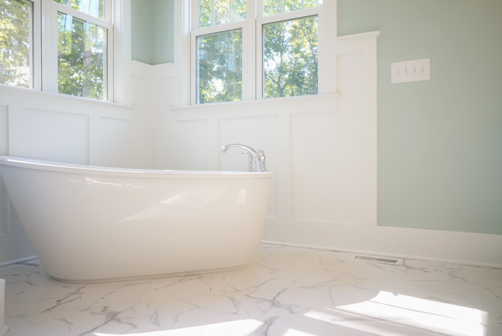 Bathroom - mid-sized craftsman master white tile and ceramic tile marble floor and white floor bathroom idea in Raleigh with shaker cabinets, white cabinets, a two-piece toilet, blue walls, an undermount sink, granite countertops and a hinged shower door