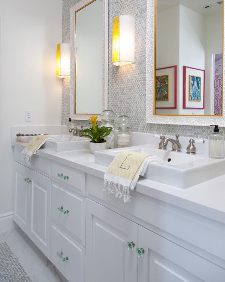 Contemporary ensuite bathroom in Orange County with raised-panel cabinets, white cabinets, white tiles, white walls, marble flooring, a vessel sink, quartz worktops and white floors.